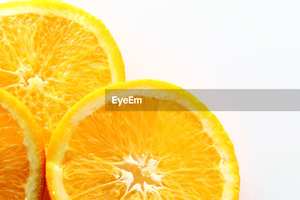 Close-up of orange slice against white background