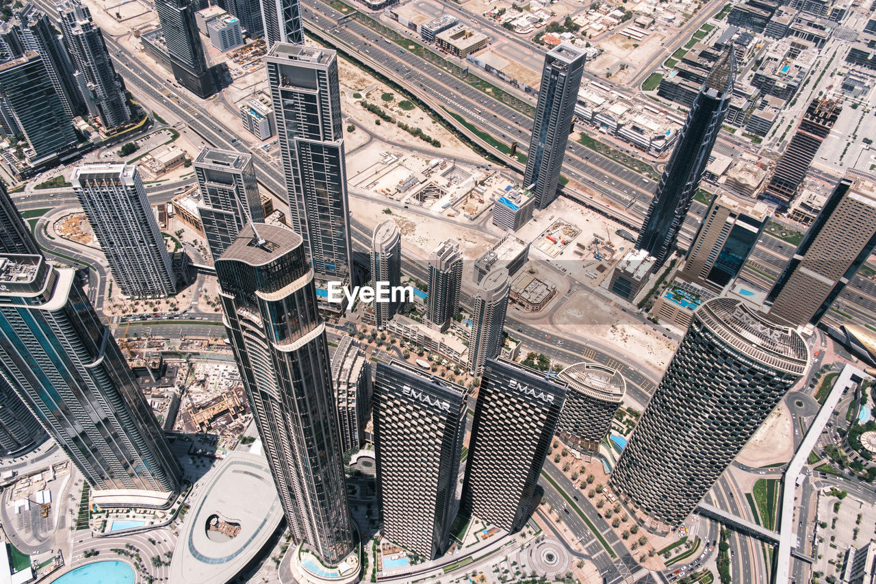 metropolis, aerial photography, city, architecture, bird's-eye view, neighbourhood, metropolitan area, built structure, building exterior, urban area, cityscape, residential area, building, high angle view, aerial view, urban design, skyscraper, downtown, no people, landmark, suburb, residential district, office building exterior, travel destinations, day, landscape, street, outdoors, backgrounds, skyline, full frame, tower block, city life, nature, roof, business finance and industry