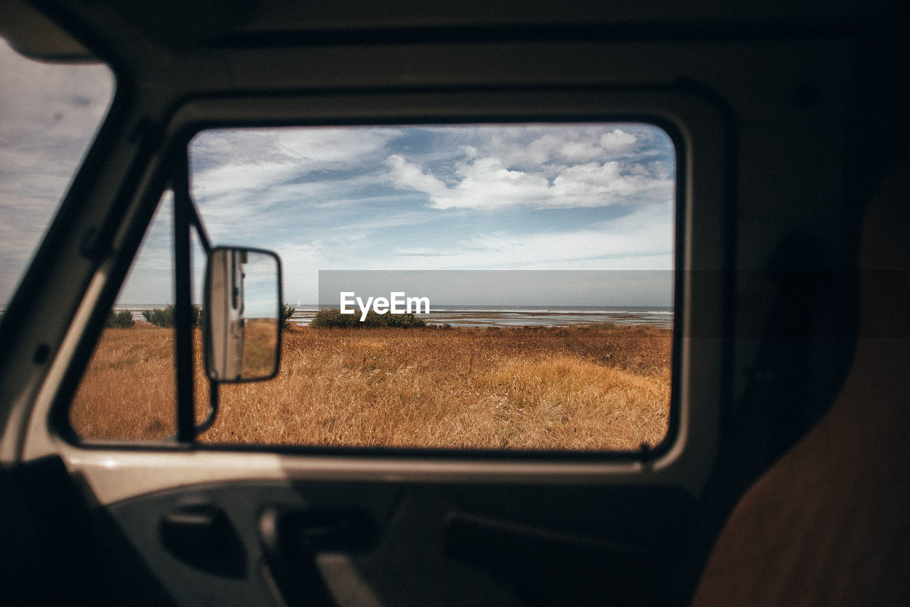 Reflection of sky on side-view mirror