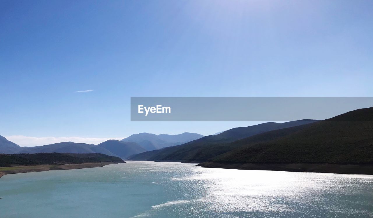 Scenic view of mountains against clear blue sky