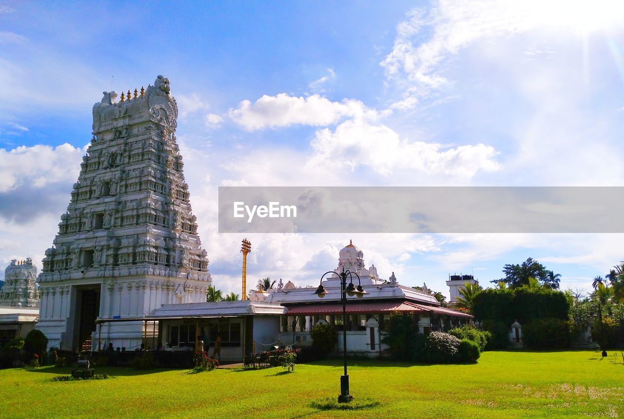 Low angle view of temple against cloudy sky