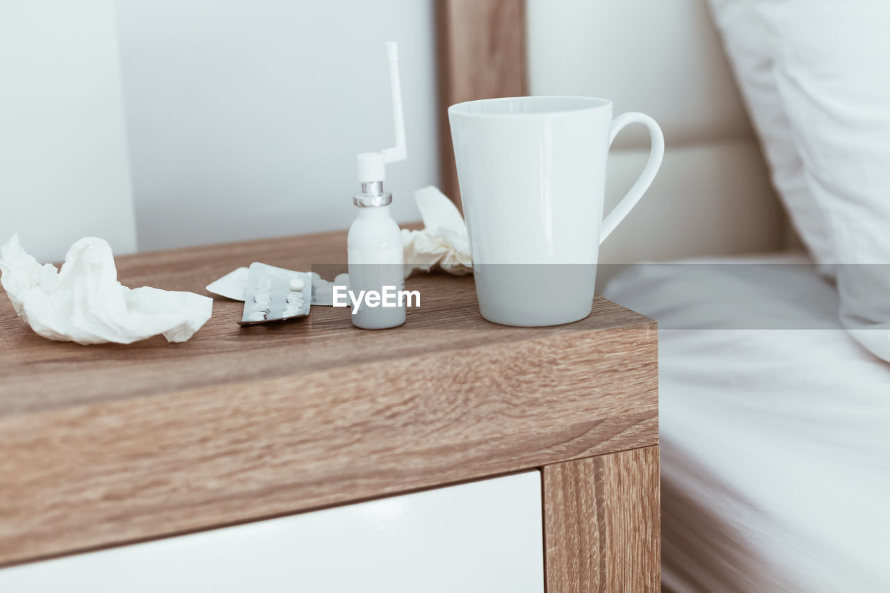 CLOSE-UP OF CUP AND COFFEE ON TABLE