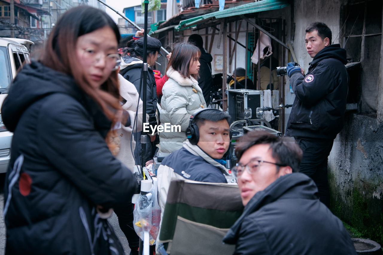 YOUNG COUPLE LOOKING AT CITY IN BACKGROUND