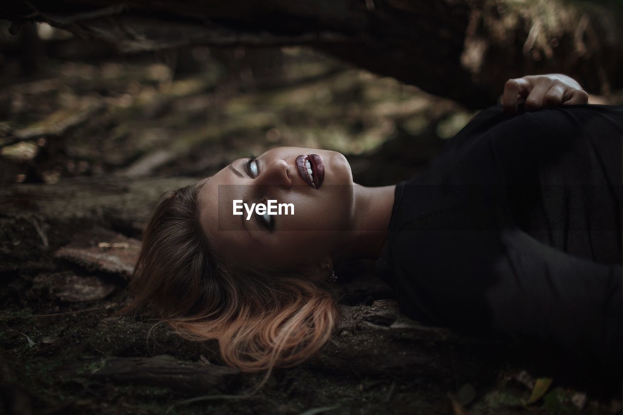 Woman with blind eyes in forest