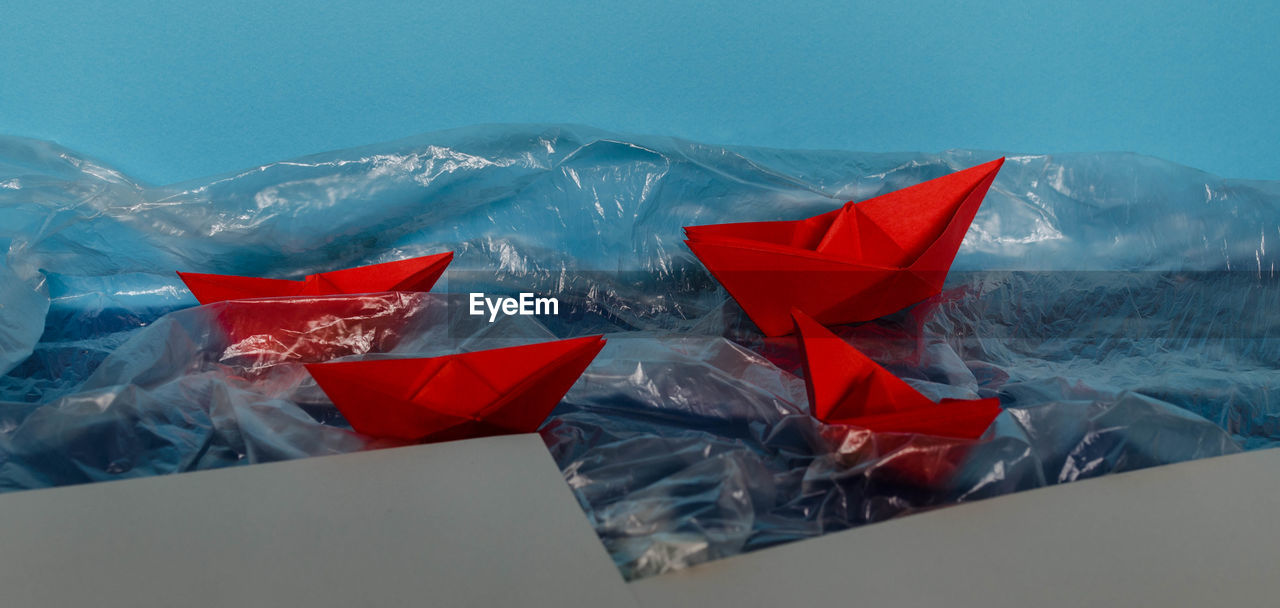 LOW ANGLE VIEW OF PAPER FLAGS AGAINST CLEAR SKY