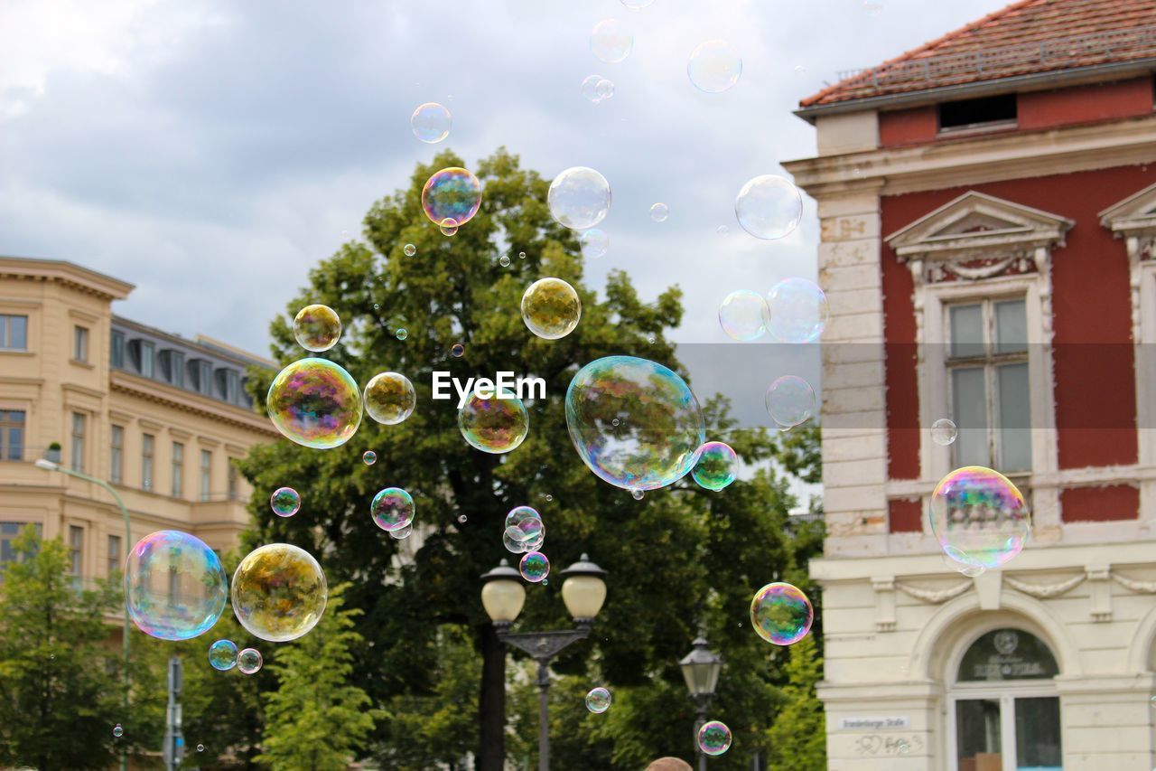 Low angle view of bubbles and trees