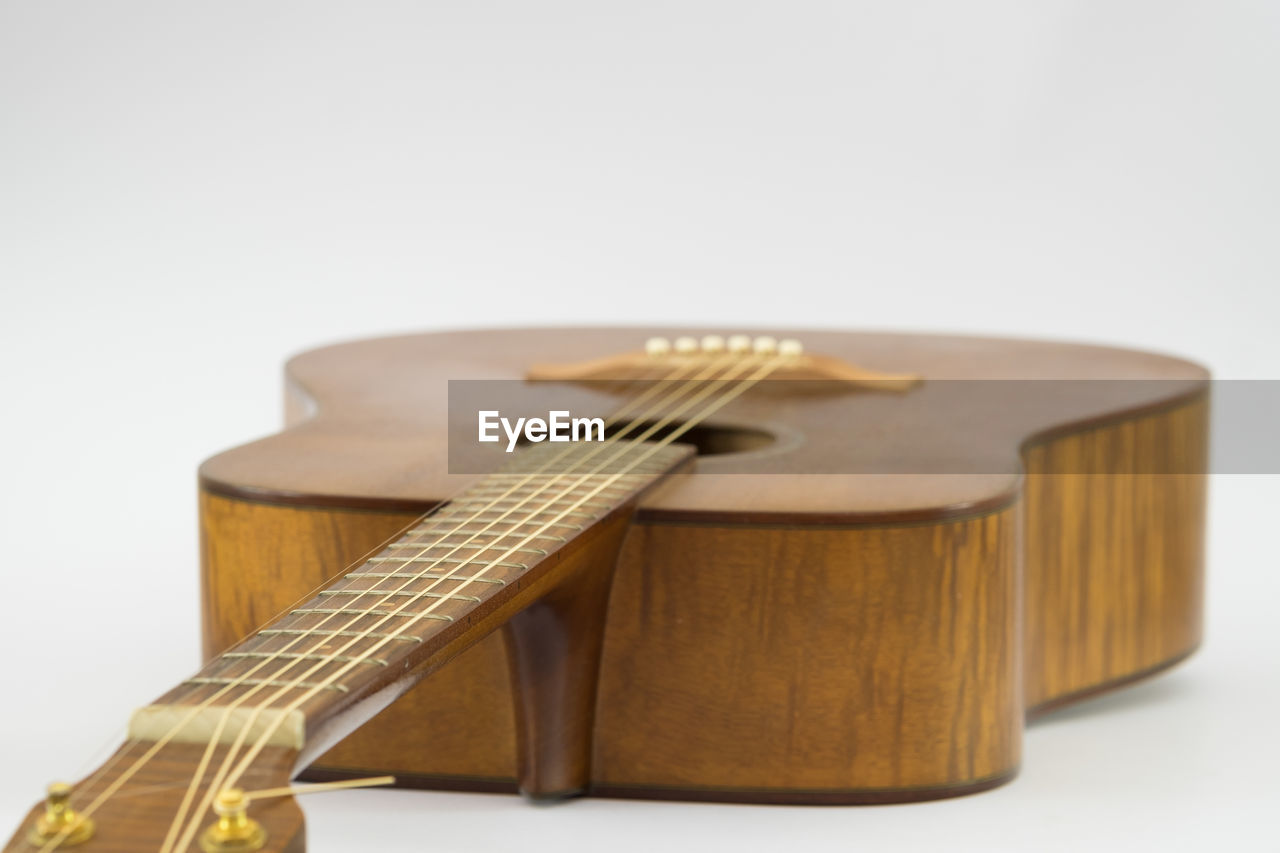 Close-up of guitar against white background