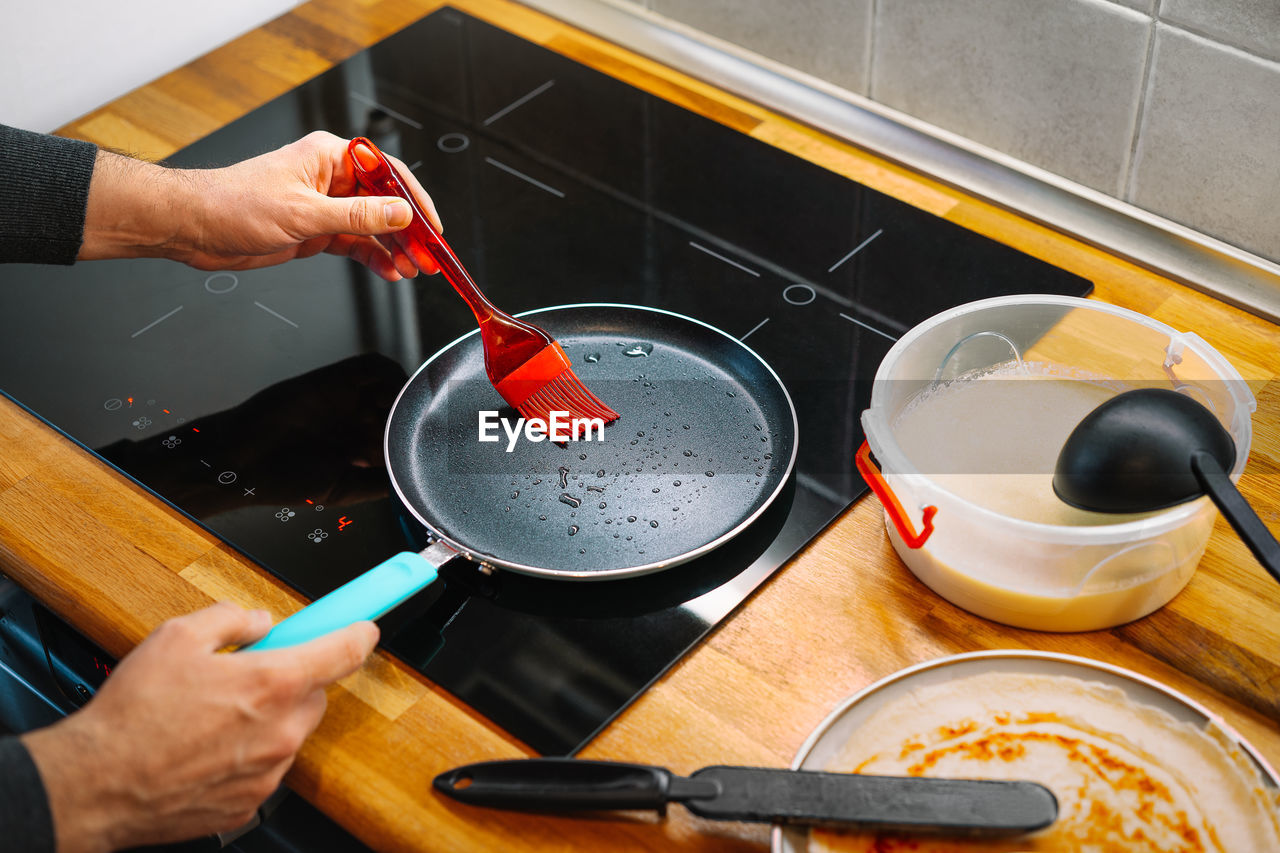 High angle view of person preparing pancakes at home in the kitchen