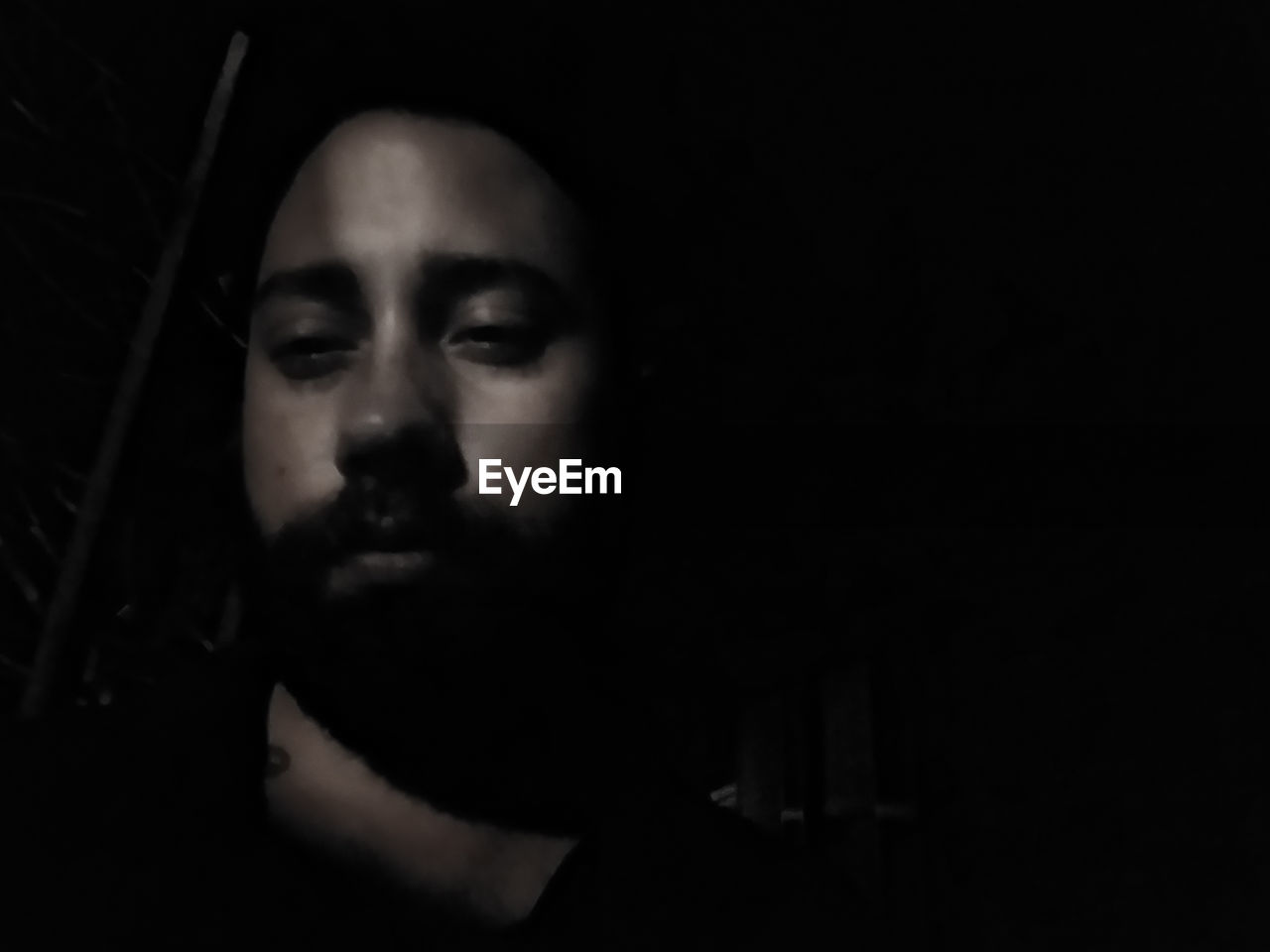 PORTRAIT OF MAN IN DARKROOM