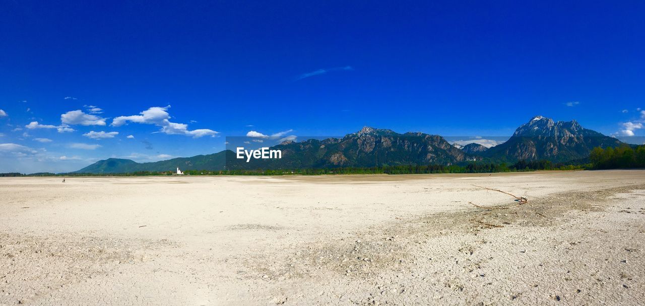 Scenic view of desert against blue sky