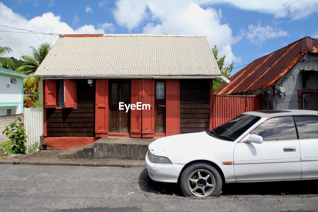 VIEW OF RED CAR AGAINST SKY