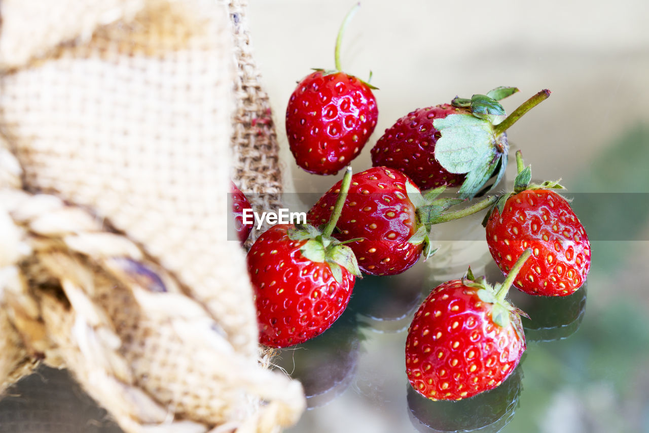 Close-up of strawberries in jute on table