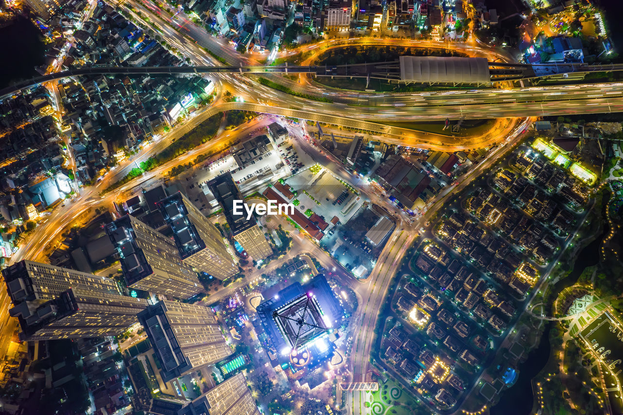 HIGH ANGLE VIEW OF ILLUMINATED BUILDINGS IN CITY