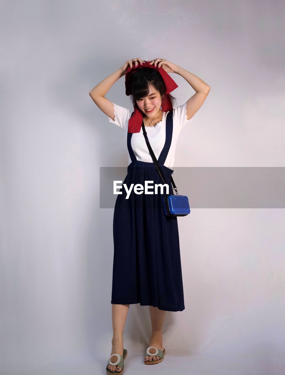 one person, women, clothing, full length, studio shot, adult, portrait, fashion, young adult, indoors, dress, looking at camera, standing, smiling, happiness, emotion, photo shoot, hand, hairstyle, female, shoe, gray, front view, arts culture and entertainment, gray background, person, brown hair, costume, cheerful, holding