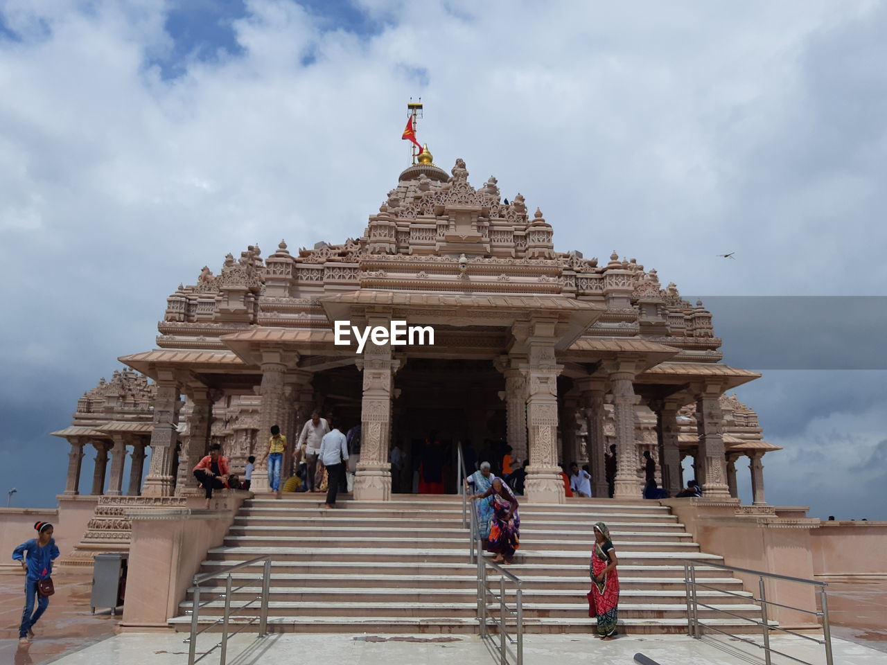 GROUP OF PEOPLE OUTSIDE TEMPLE