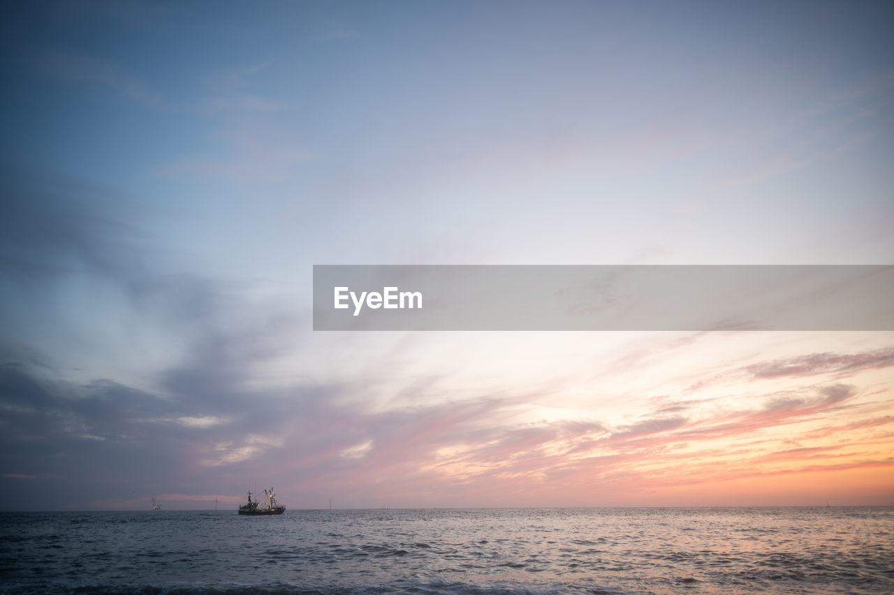 sky, sea, water, horizon, cloud, horizon over water, ocean, sunset, nautical vessel, beauty in nature, scenics - nature, nature, sunlight, transportation, dawn, tranquility, tranquil scene, wave, mode of transportation, evening, shore, reflection, ship, coast, sailing, outdoors, no people, travel, seascape, dramatic sky, sun, idyllic, beach, afterglow, silhouette, blue, land, copy space