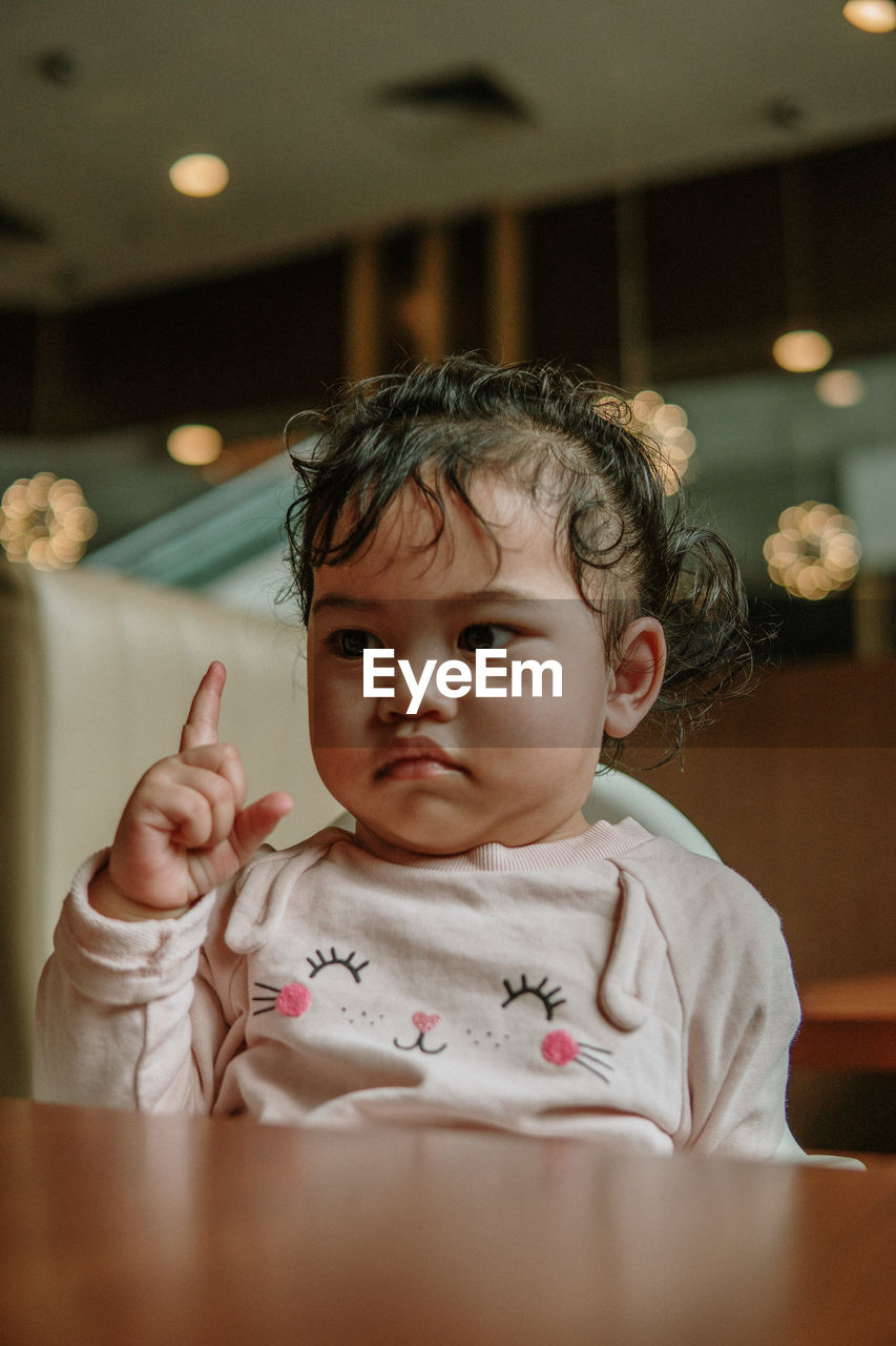 Portrait of cute baby girl at home