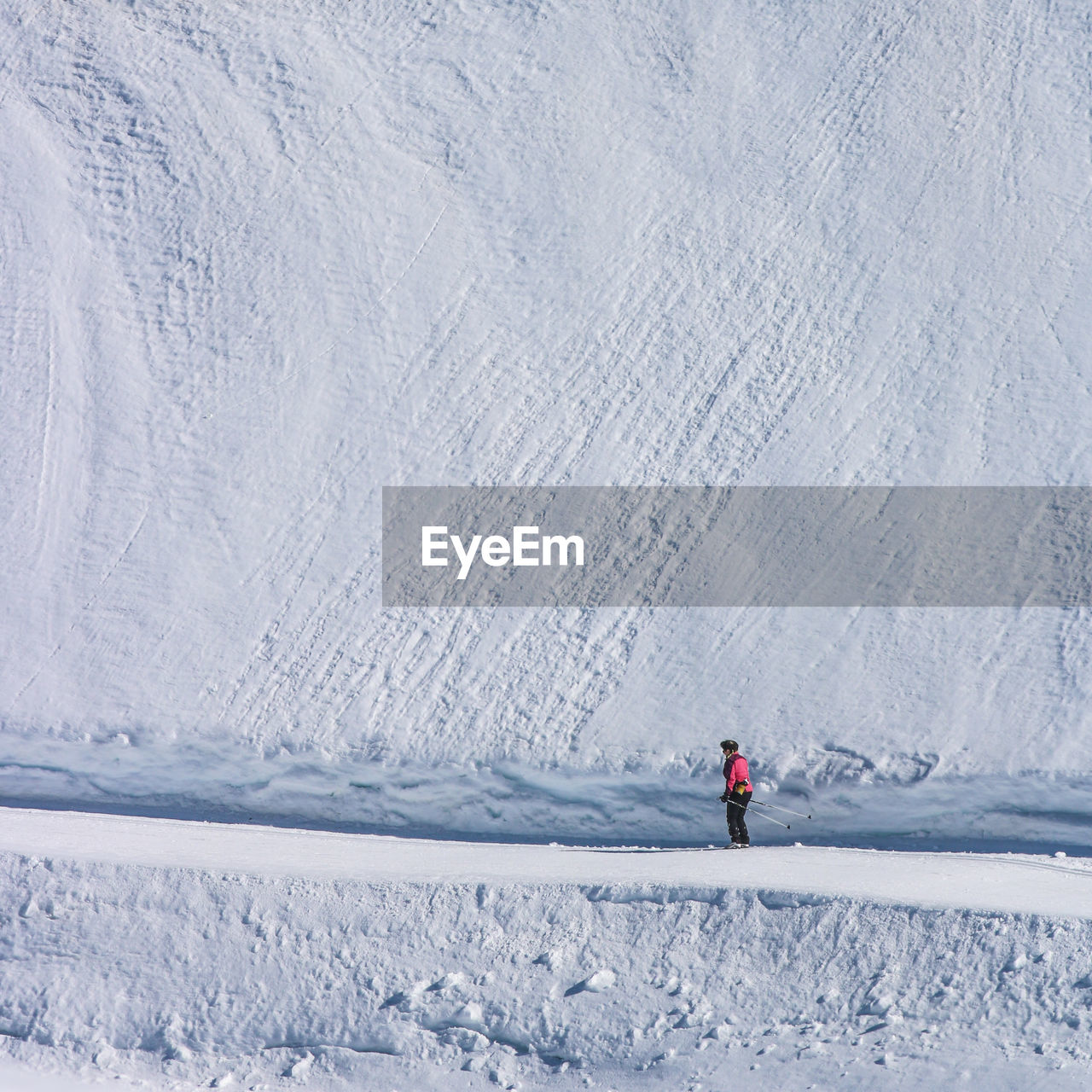 Woman standing on snowcapped mountain