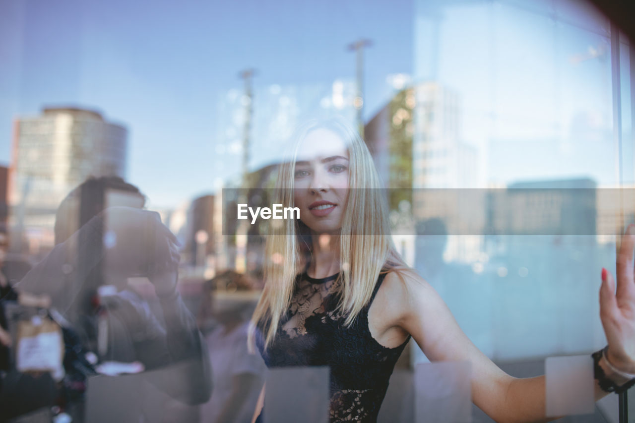 Reflection of woman in glass building