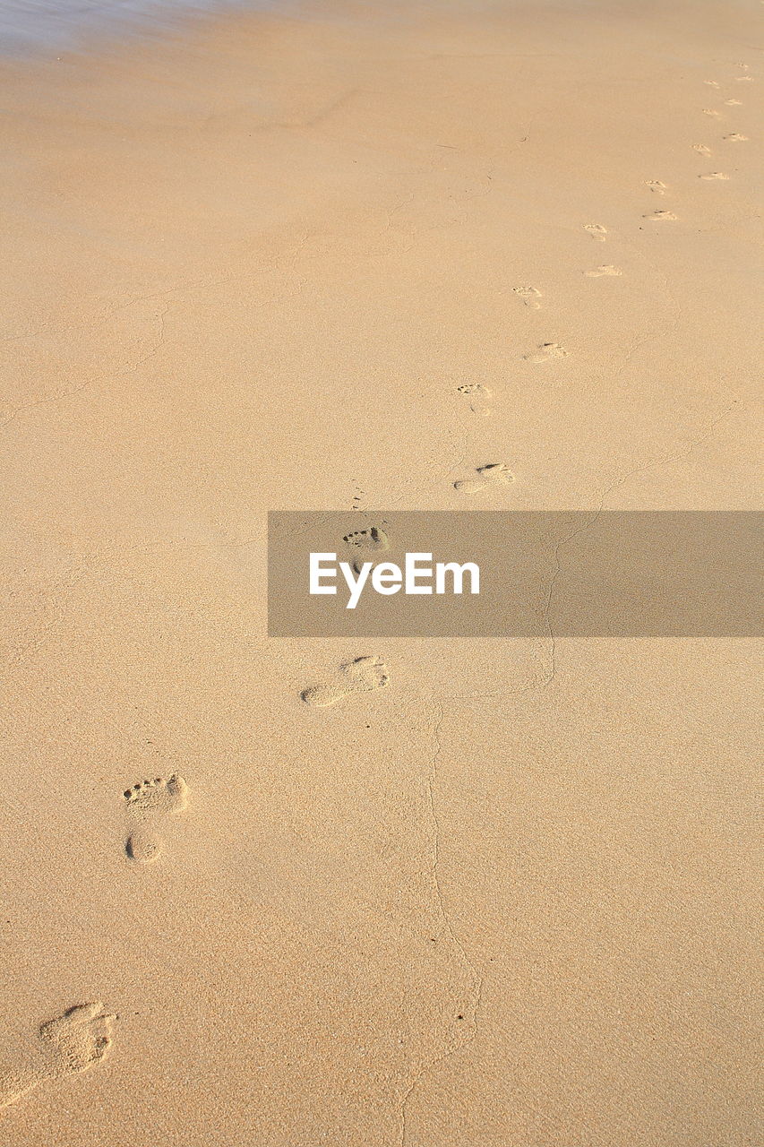 High angle view of footprint on beach