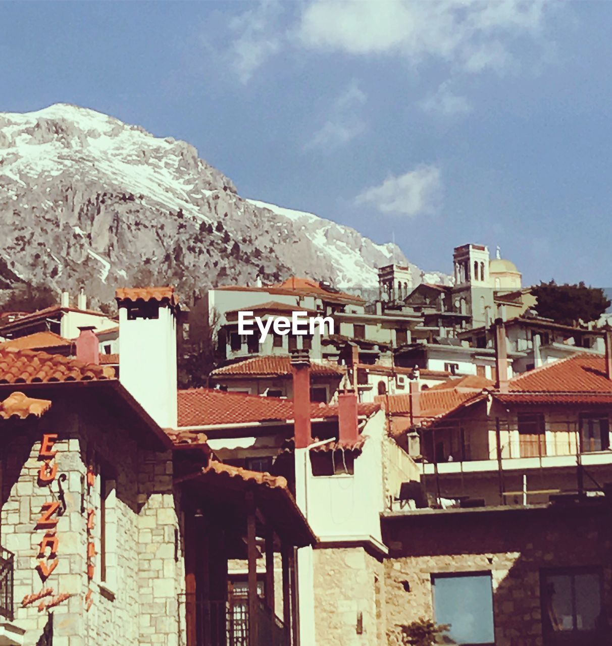 HOUSES IN WINTER AGAINST SKY