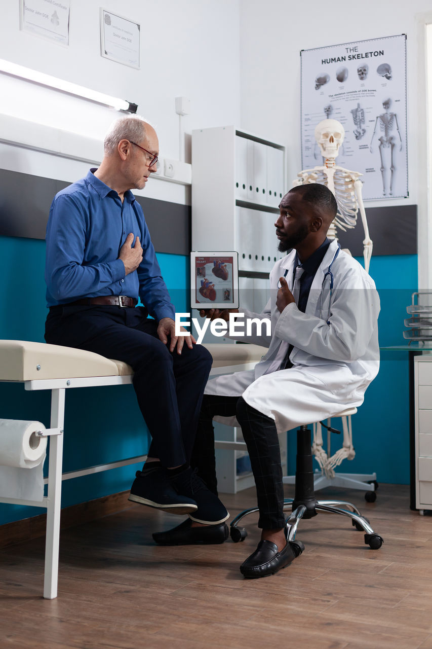 Doctor talking with patient in clinic