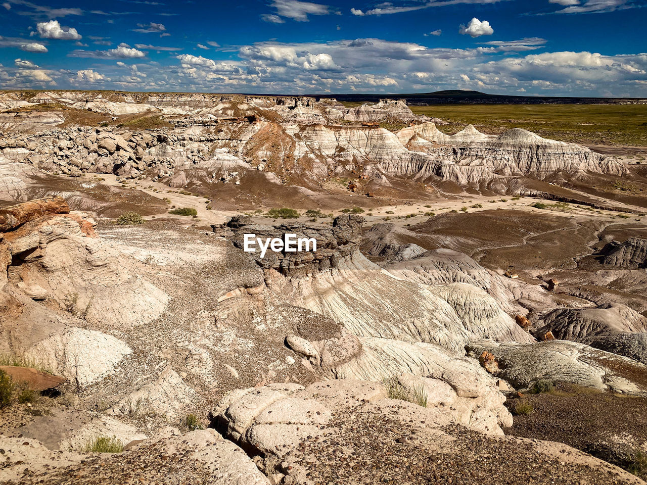 Scenic view of desert landscape against sky at petrified forest national park, united states.