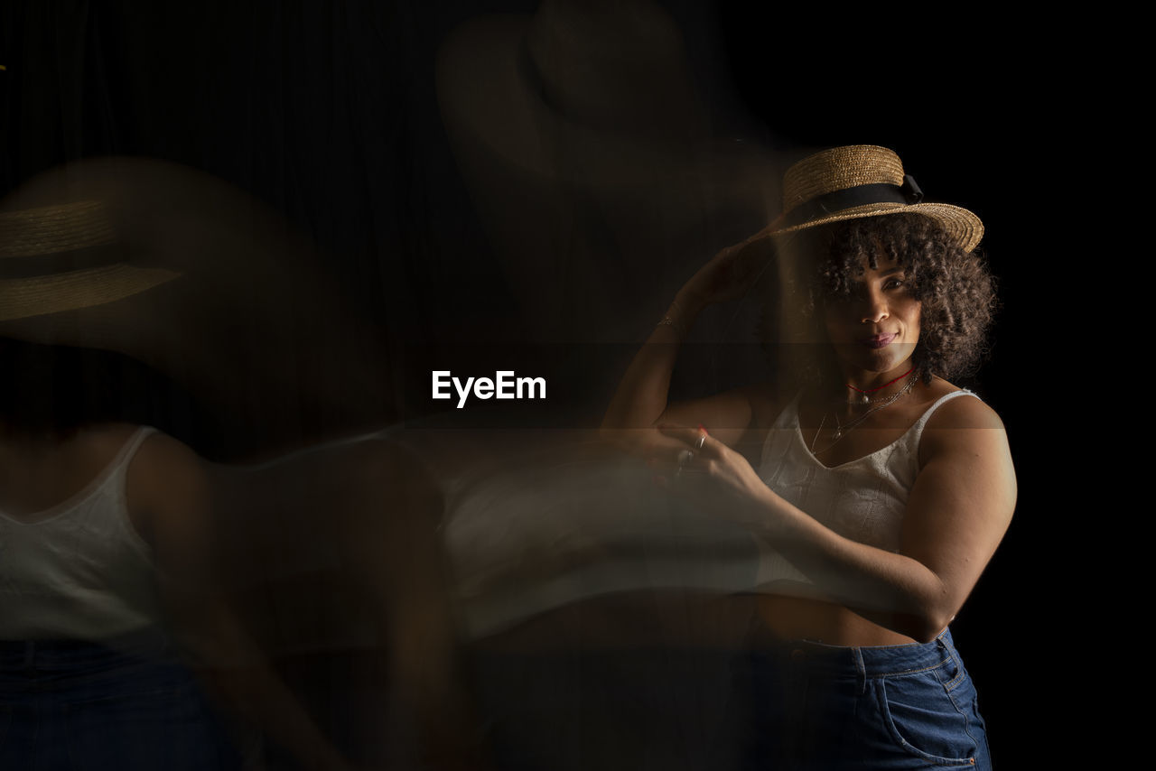 Time-lapse view of woman moving a hat. long exposure, motion blur. 