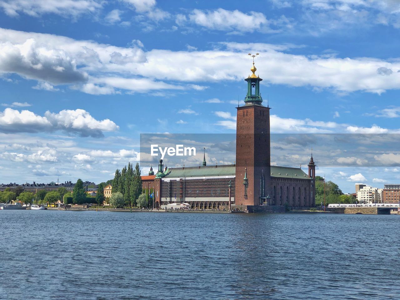 RIVER AMIDST BUILDINGS AGAINST SKY