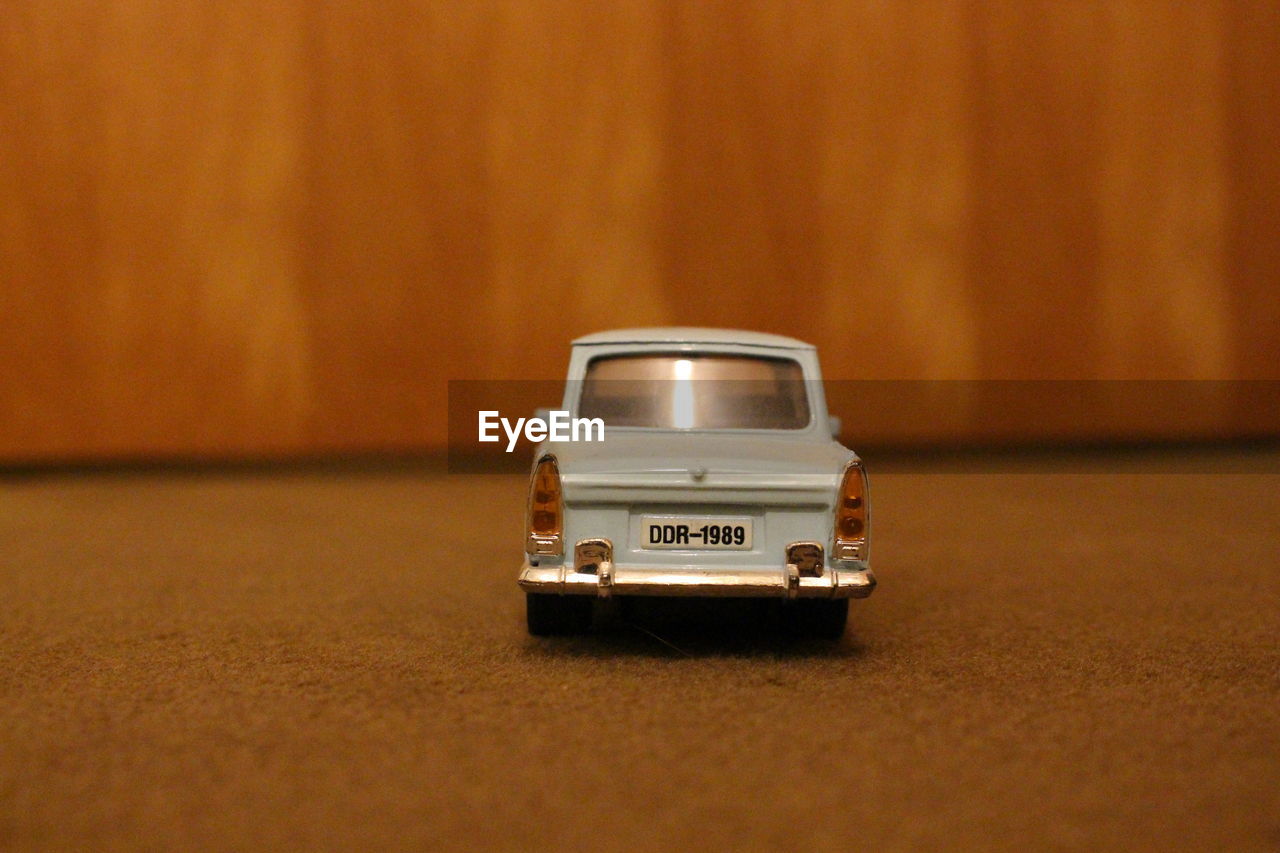 CLOSE-UP OF TOY CAR ON TABLE AT BUS