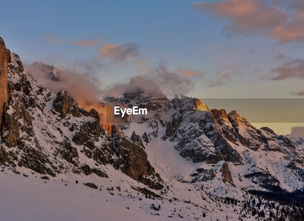 Scenic view of snowcapped mountains against sky during sunset