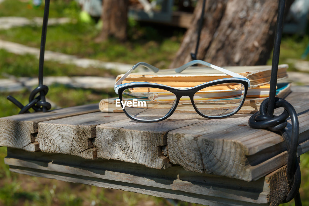 Old books and glasses on a homemade retro swing