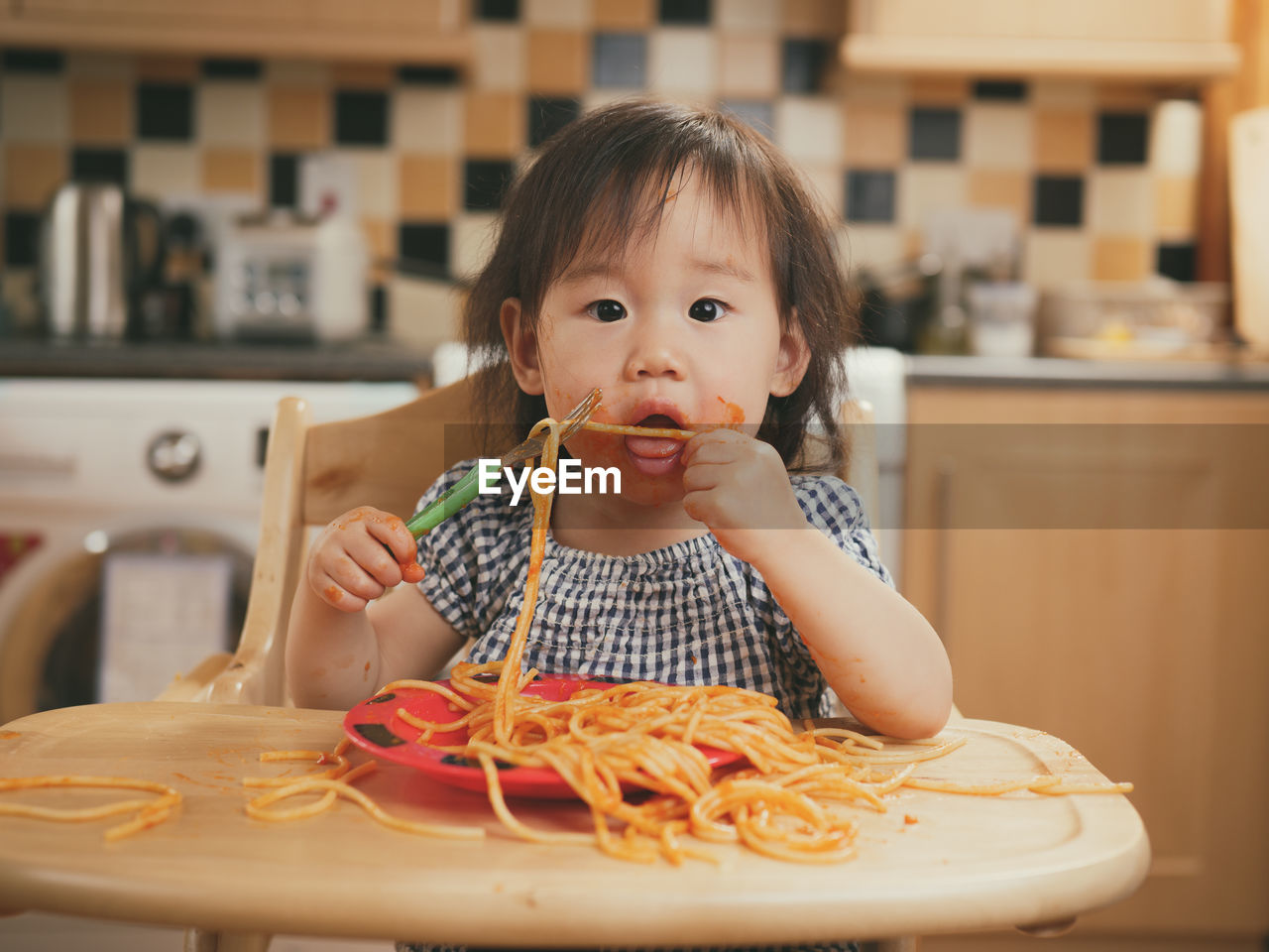 Portrait of girl eating pasta