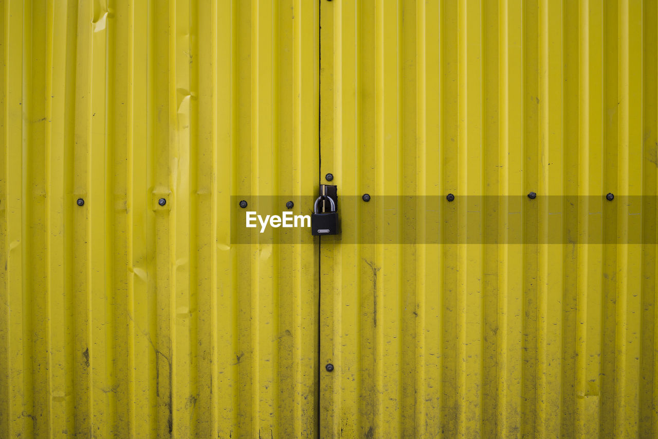 Padlock on yellow container. security and safe concept 