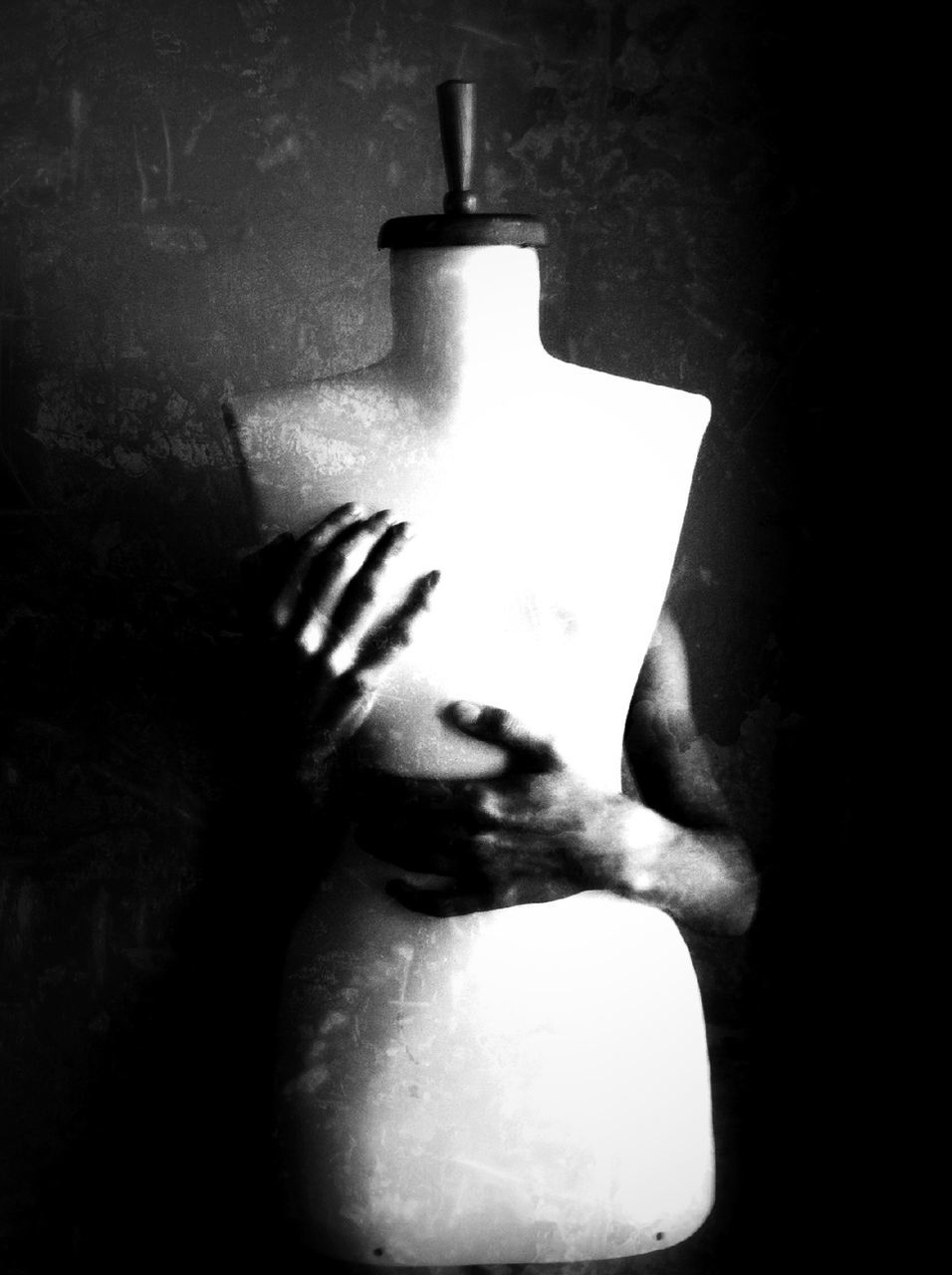 Cropped image of person covering mannequin breast