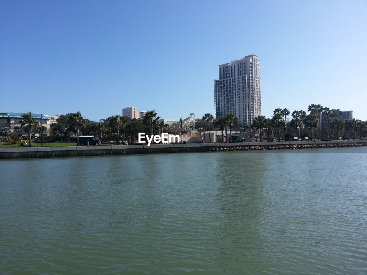 VIEW OF RIVER WITH BUILDINGS IN BACKGROUND