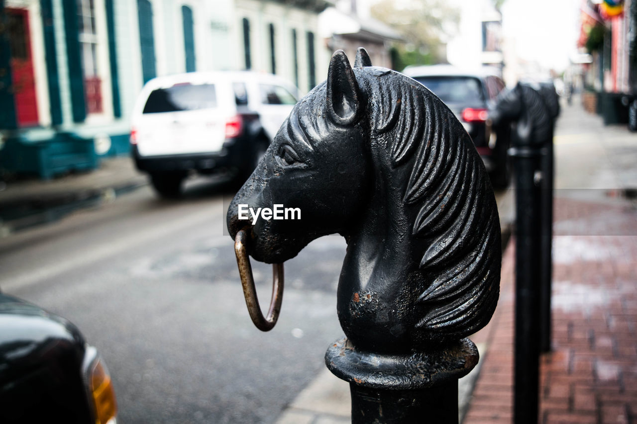 CLOSE-UP OF HORSE SCULPTURE ON STREET