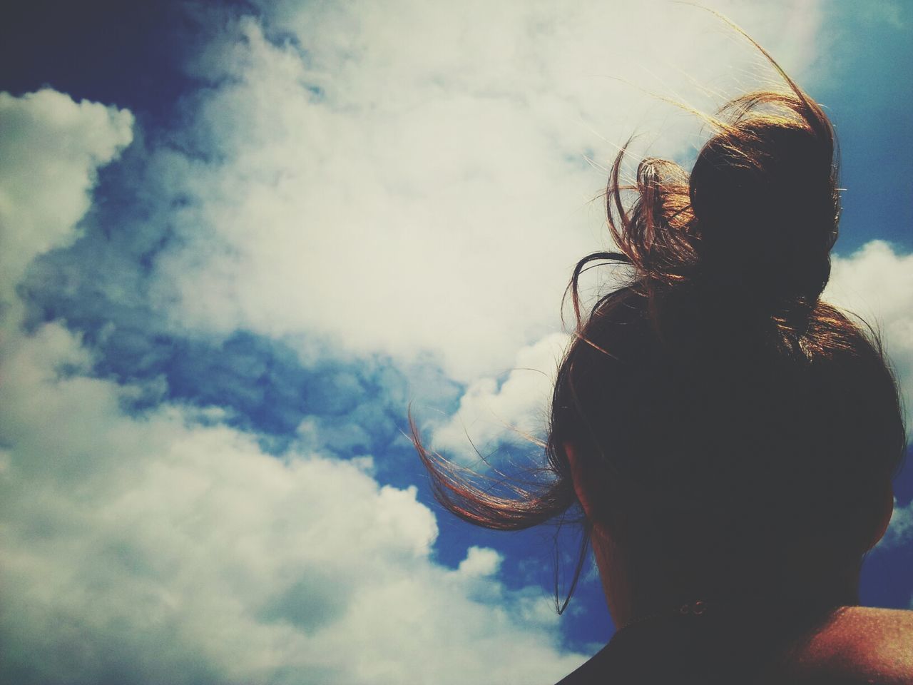 Low angle view of woman head against sky