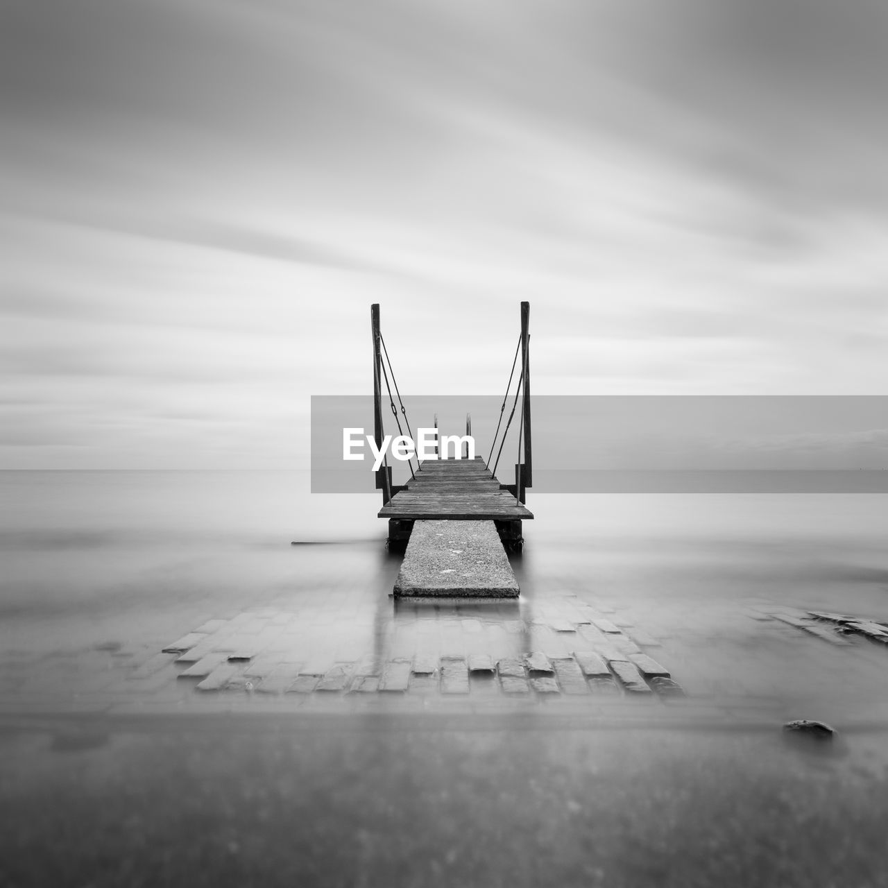 Black and white image of a bathing jetty along the lake ijsselmeer near edam, netherlandfs