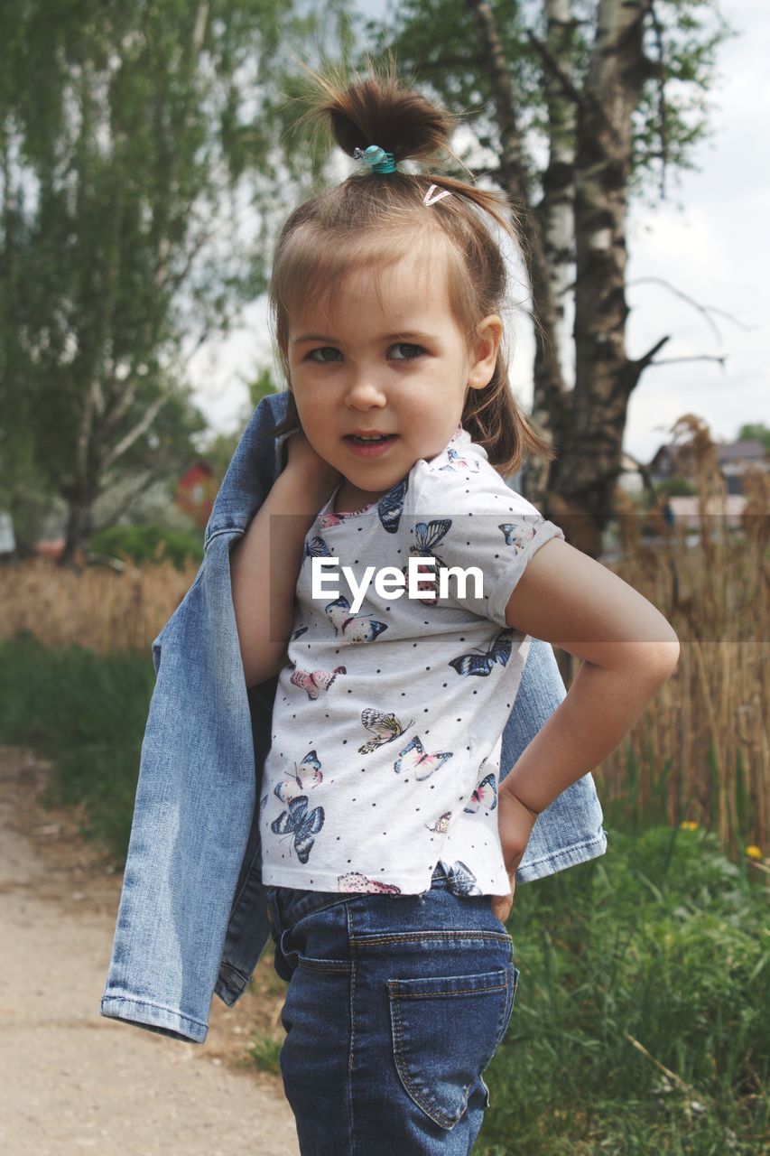 Portrait of cute girl standing on land