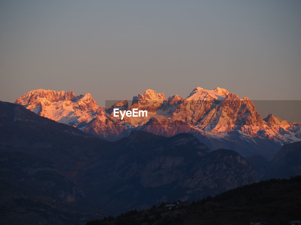 Scenic view of snowcapped mountains against sky during sunset