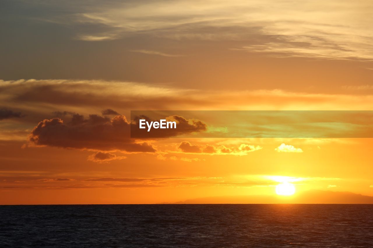 SCENIC VIEW OF SUNSET OVER SEA