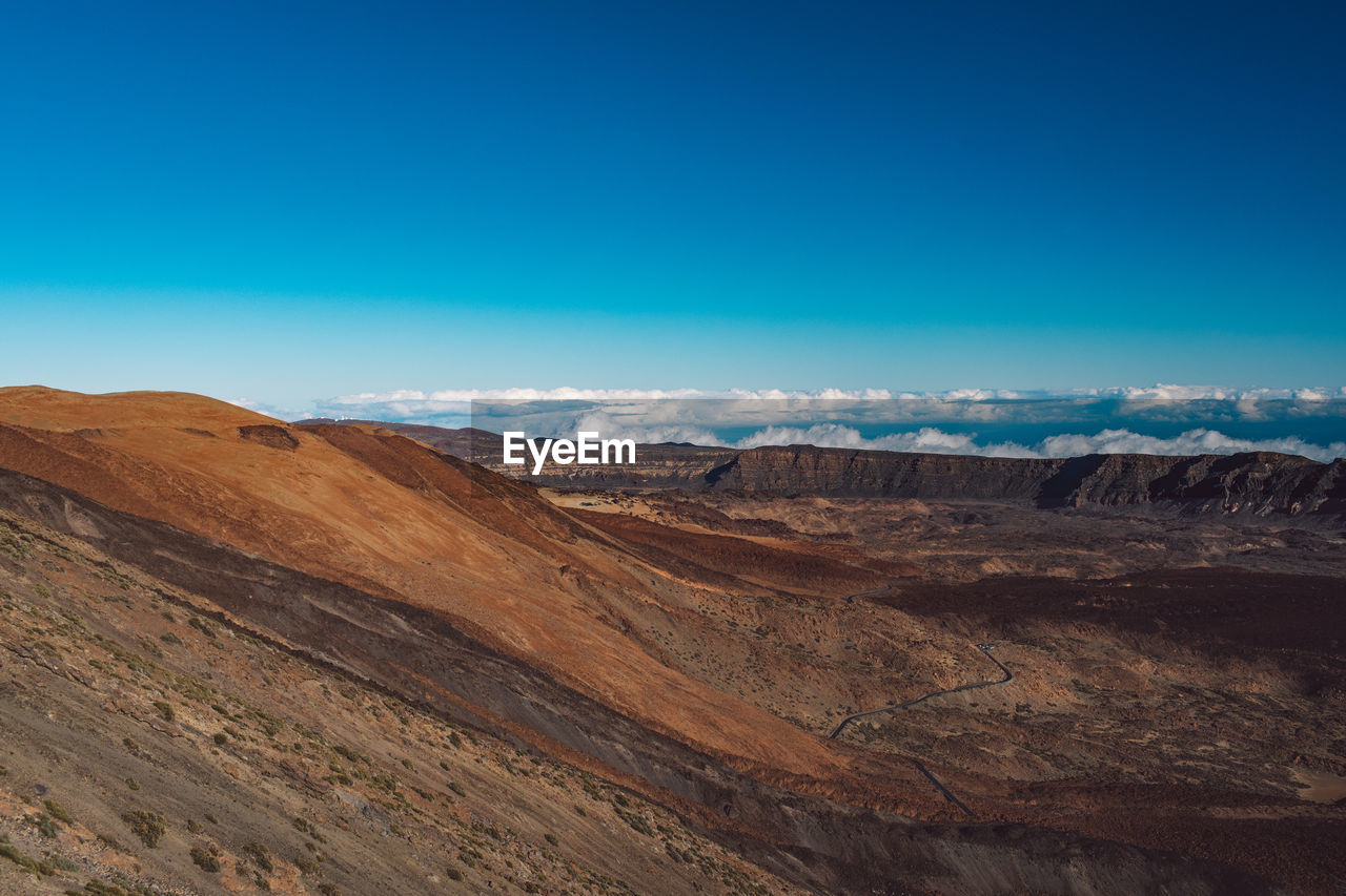 Scenic view of landscape against blue sky