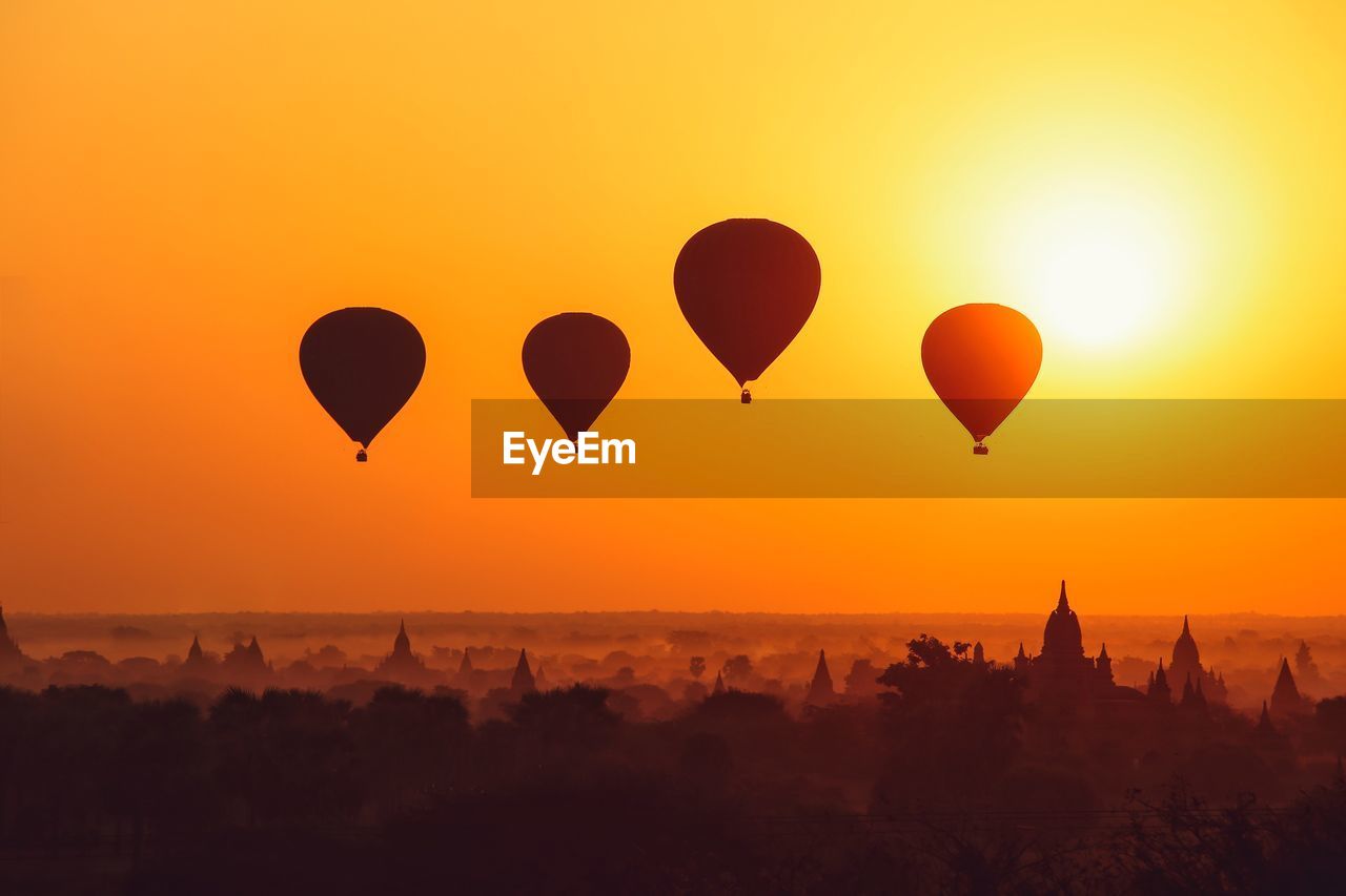 Silhouette of hot air ballons over bagan at sunrise in misty morning, myanmar 