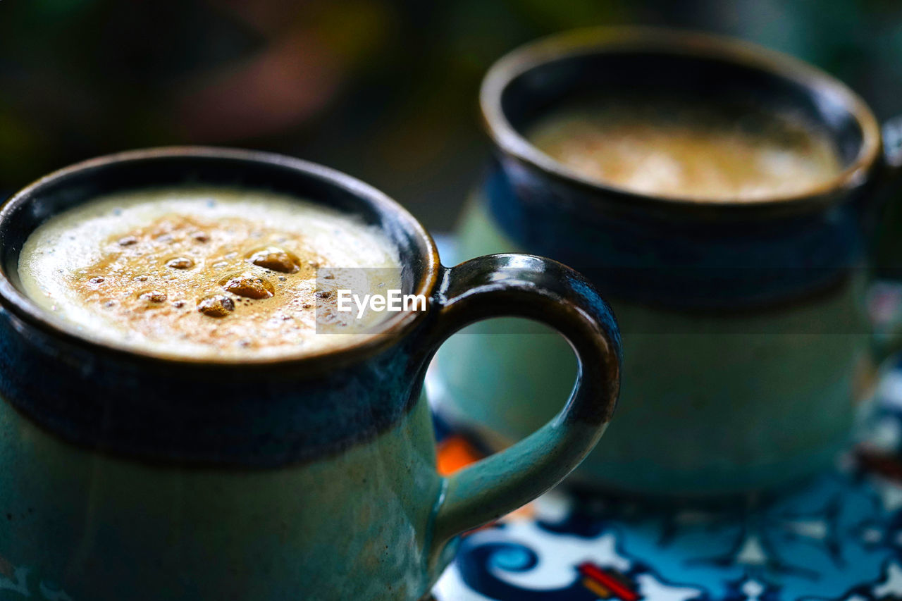 Close-up of coffee cups on table