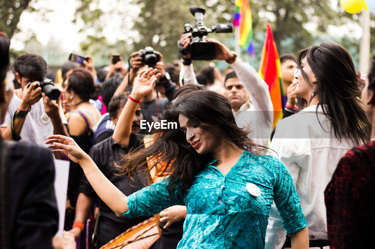 GROUP OF PEOPLE DANCING AT MUSIC FESTIVAL