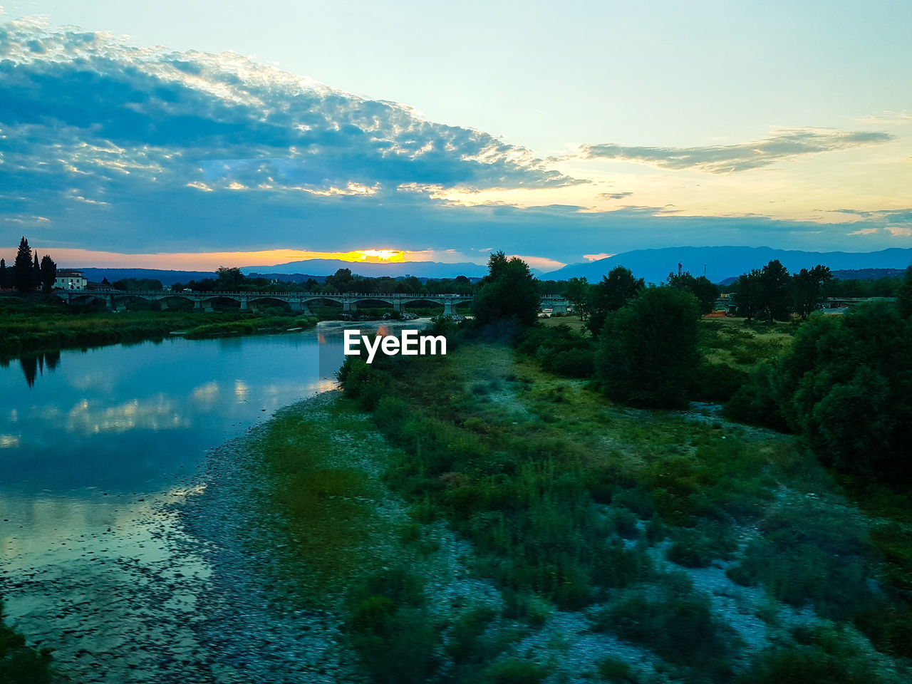 SCENIC VIEW OF LAKE BY TREES AGAINST SKY