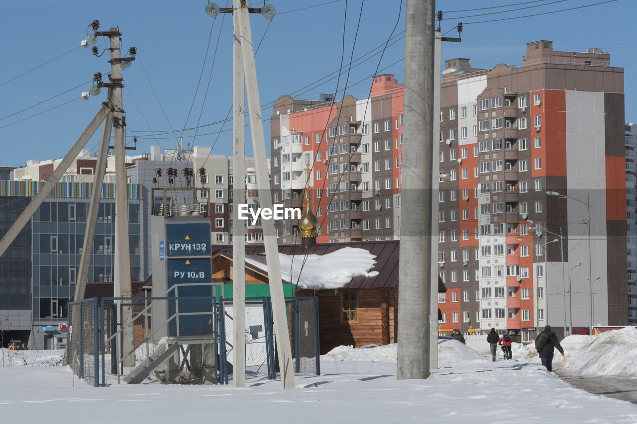 BUILDINGS IN CITY AGAINST SKY DURING WINTER