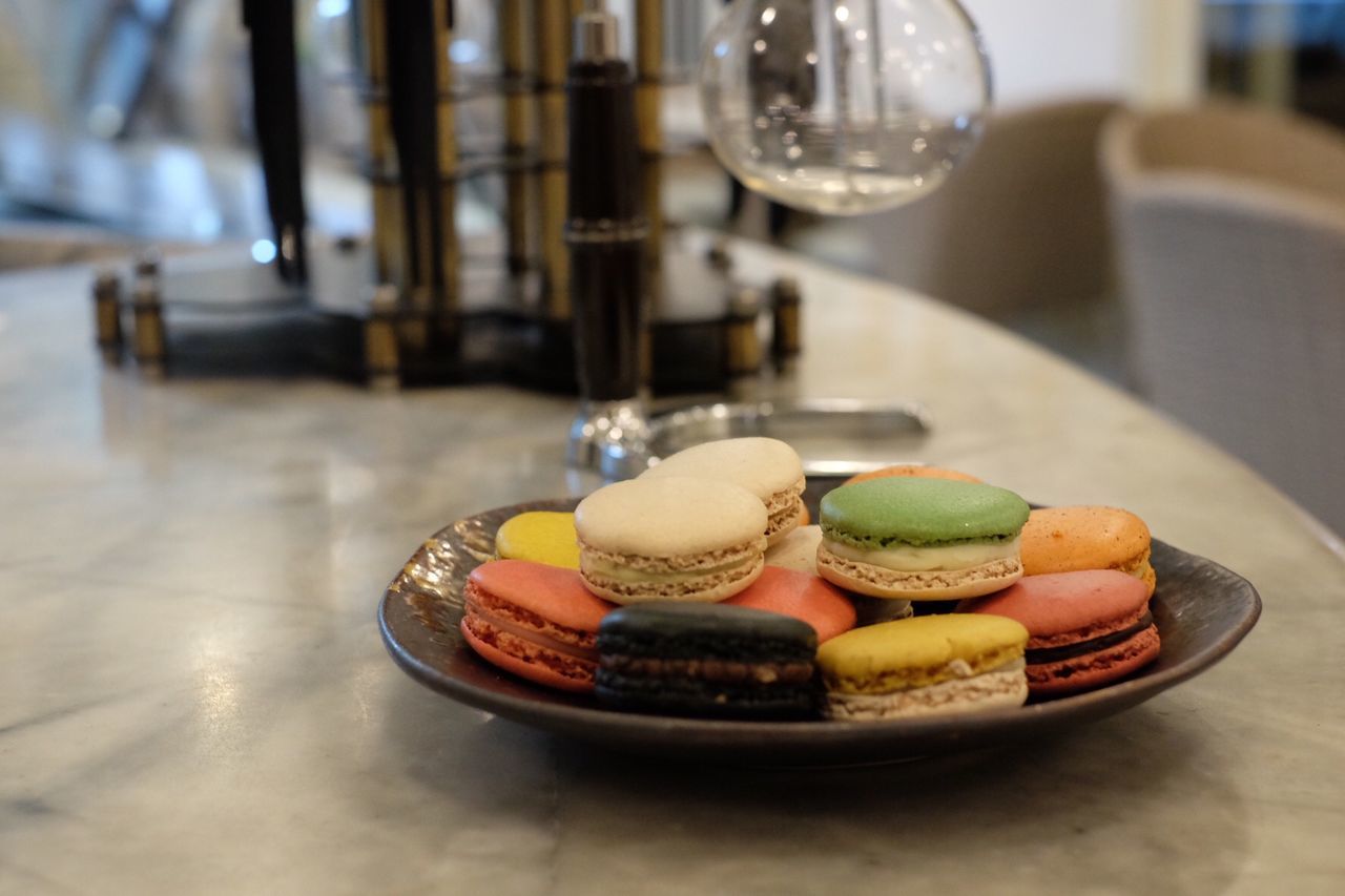 Close-up of colorful macaroons in plate on table