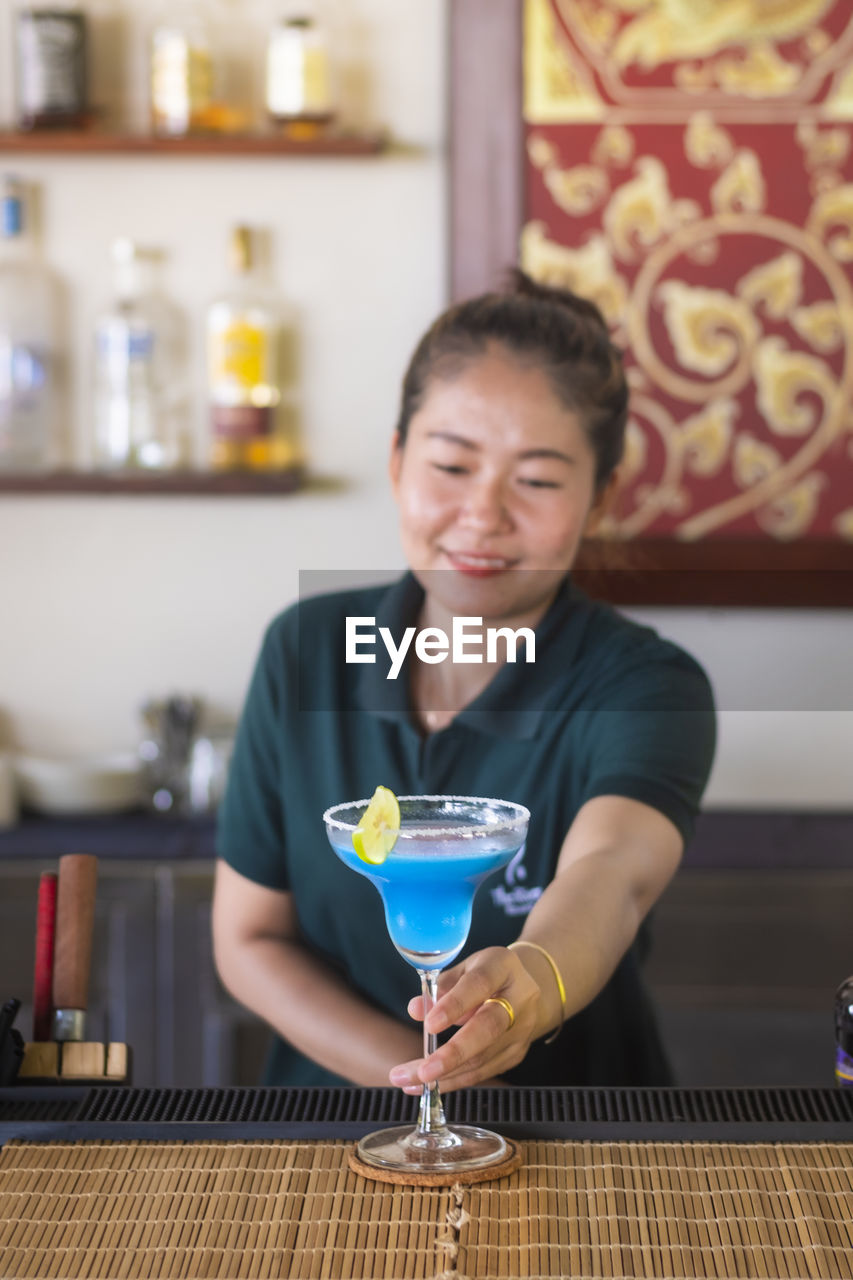 Female bartender preparing drink bar